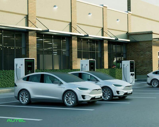 AUTEL DC fast charging stations in front of a commercial building, two electric vehicles charging